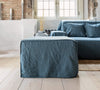 Ocean blue linen couch cover designed and crafted to elevate your interior with a fresh look and great energy. It offers a practical solution for safeguarding your furniture against the playful antics of your beloved pets.